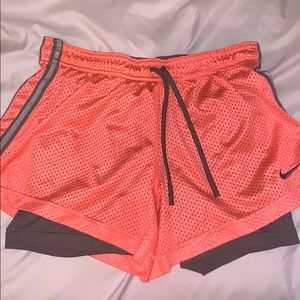 Nike bright orange running shorts